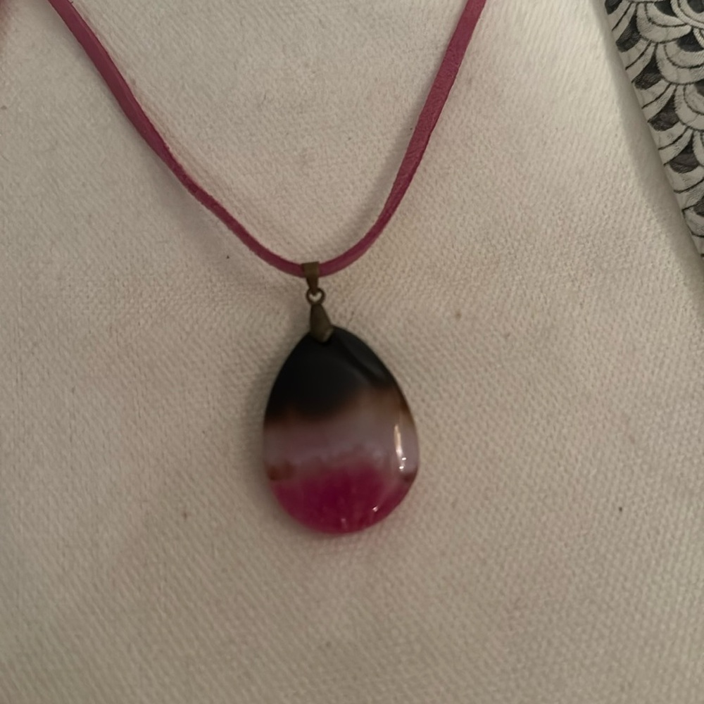 Beautiful tie-dye stone in pink, white and black on pink adjustable leather cord